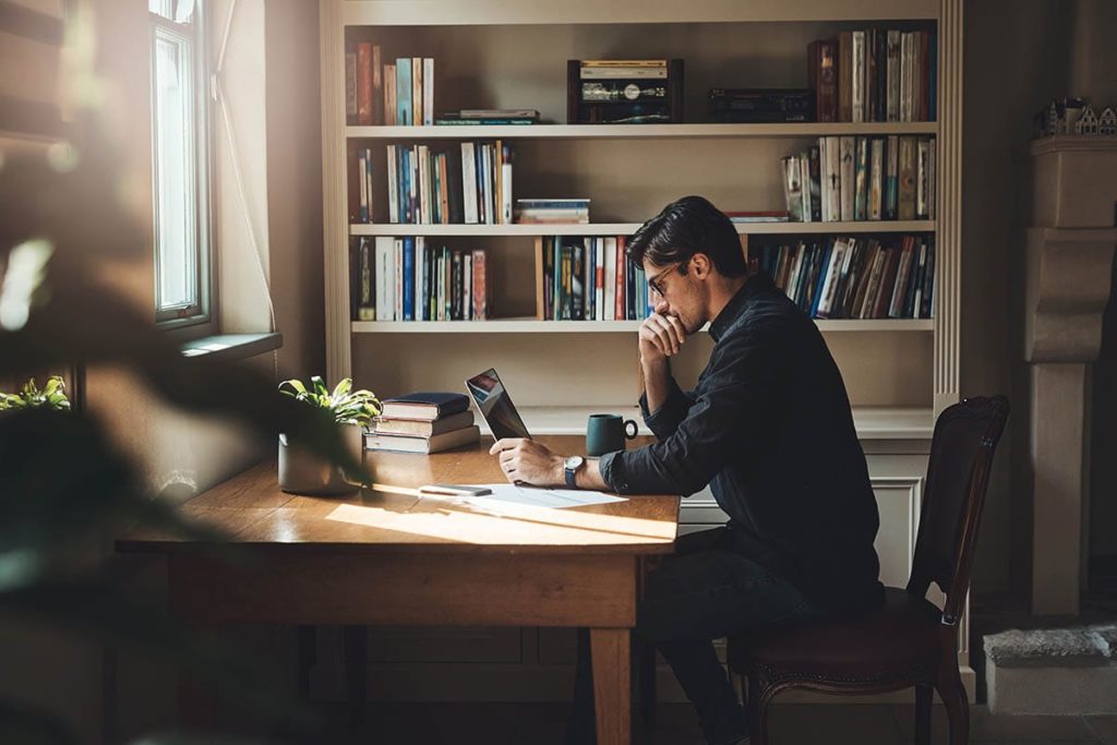 man at desk finding a treatment center for alcohol addiction