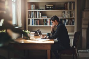 man at desk finding a treatment center for alcohol addiction