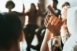 people clasping hands in an addiction treatment center