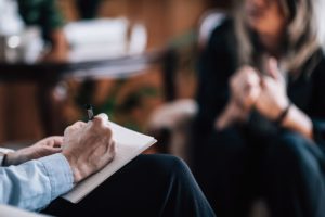 person in a therapy session discussing a psychotherapy treatment program