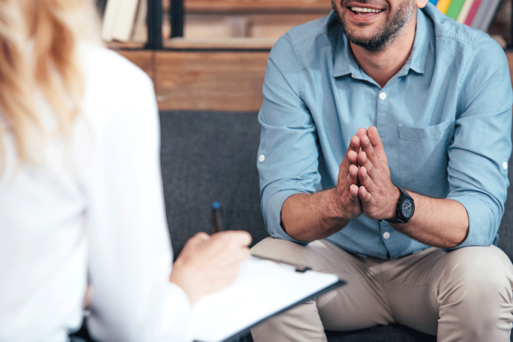 man in blue shirt talking with therapist about dialectical behavior therapy techniques