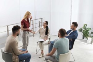people in group therapy sessions discuss rehab for opioid addiction