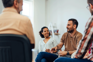 people talking in a group therapy session at an alcohol detox center