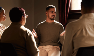 man in a group session in an outpatient program