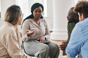 woman talks with peers in group therapy about polysubstance abuse
