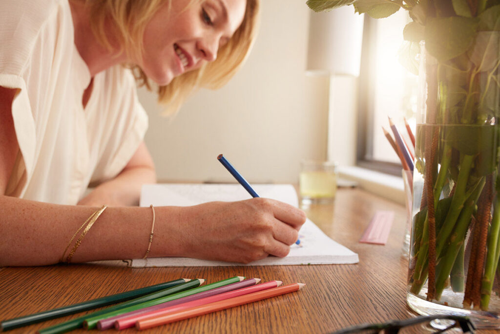 person sketching with colored pencils as one of many self-care activities to help depression